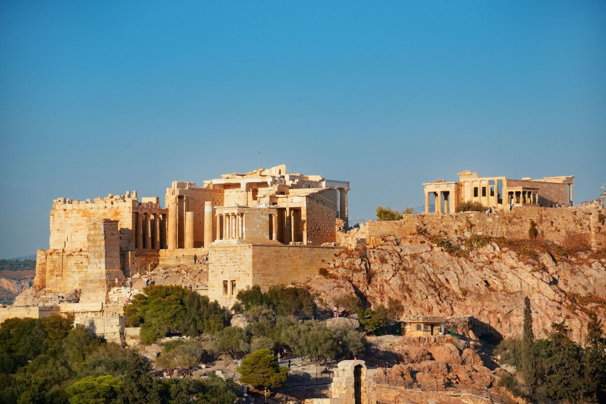 The Acropolis of Athens on a clear day, showcasing the Parthenon and surrounding ruins.